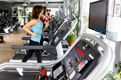 Fitnesstudio von innen, Frau l&auml;uft auf dem Laufband