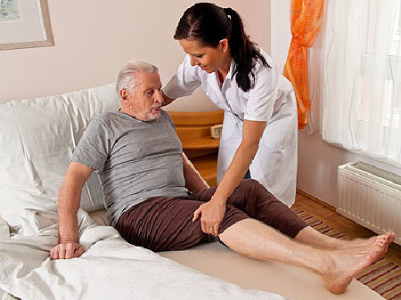 Pflegekraft hilft älterem Mann aus dem Bett © Gina Sanders, Fotolia.com