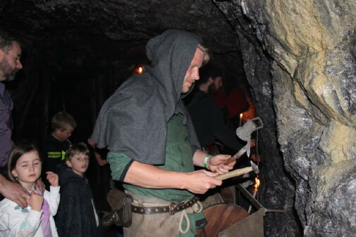 Ein Mann in historischer Knappenkleidung bei einer F&uuml;hrung mit Kindern in der Knappenwelt Gurgltal